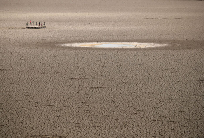 FILE PHOTO: Children play as caked clay is seen in the dried up municipal dam in drought-stricken Graaff-Reinet drought south africa