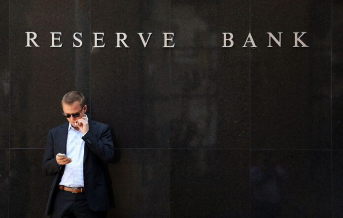 A man smokes next to the Reserve Bank of Australia headquarters in central Sydney Reserve Bank Sydney