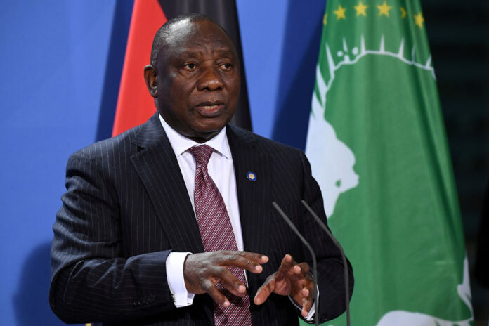 FILE PHOTO: South African President Cyril Ramaphosa addresses a press conference after the G20 Compact with Africa conference at the Chancellery in Berlin South Africa Moves to Adjusted Alert Level 1