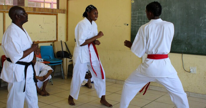 Sensei Mandla Nkonde (wearing a black belt) with students Oratwa Tsosane and Boipelo Mongale. During the week Nkonde works as a reclaimer and at the weekend he becomes sensei to over a dozen children who attend his karate classes in Orlando West, Soweto. Photos: Masego Mafata
