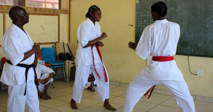 recycling-to-black-belt-gup Sensei Mandla Nkonde (wearing a black belt) with students Oratwa Tsosane and Boipelo Mongale. During the week Nkonde works as a reclaimer and at the weekend he becomes sensei to over a dozen children who attend his karate classes in Orlando West, Soweto. Photos: Masego Mafata
