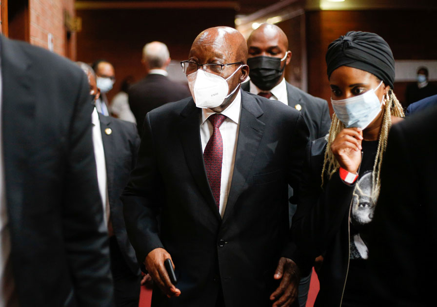 South Africa's former president Jacob Zuma walks with his daughter Duduzile Zuma-Sambdula after appearing in the High Court in Pietermaritzburg