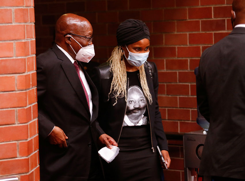 South Africa's former president Jacob Zuma walks with his daughter Duduzile Zuma-Sambdula after appearing in the High Court in Pietermaritzburg