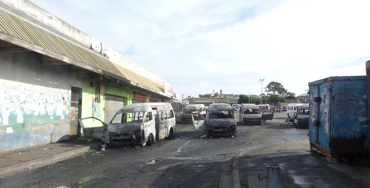 Several minibus taxis and a car were torched in Korsten, Gqeberha on Wednesday following violent clashes between taxi operators and local business owners. Photo: Joseph Chirume