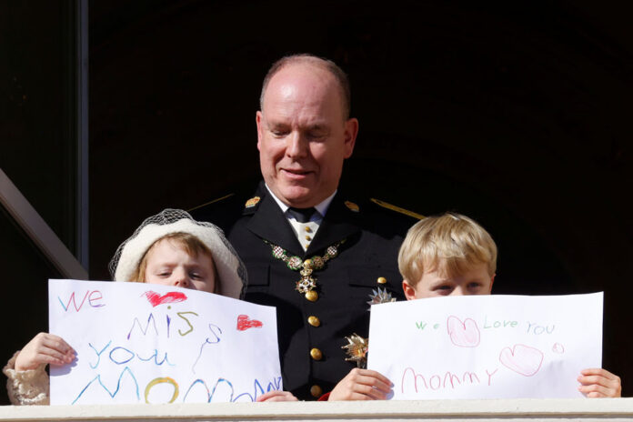 Celebrations marking Monaco's National Day Prince Albert II of Monaco, Prince Jacques and Princess Gabriella holding message which read