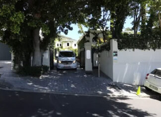 A hearse carries the body of FW de Klerk from his home in Cape Town earlier today. Photo: Reuters video keyframe