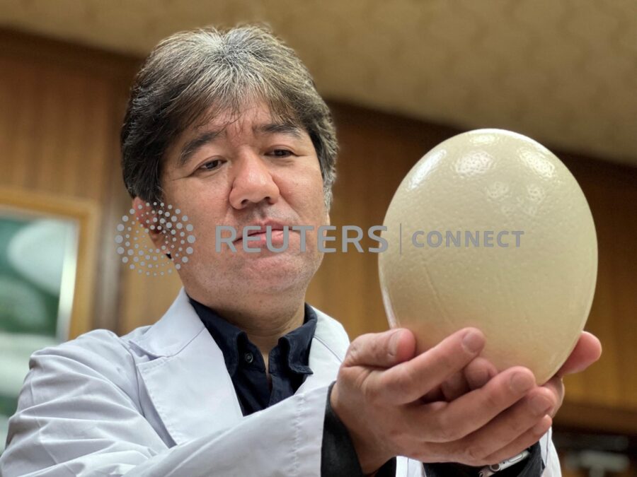 KPU President Tsukamoto holding ostrich egg in Kyoto