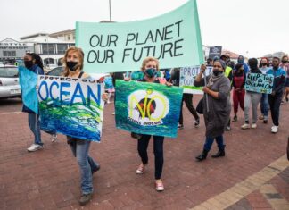 Protesters in Muizenberg, Cape Town call for Shell’s seismic survey on the Wild Coast to be stopped. Photo: Ashraf Hendricks