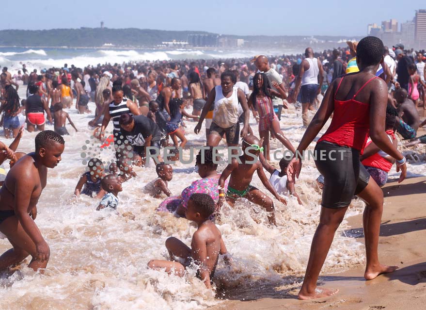 Revellers enjoy New Year's Day on a beach, in Durban