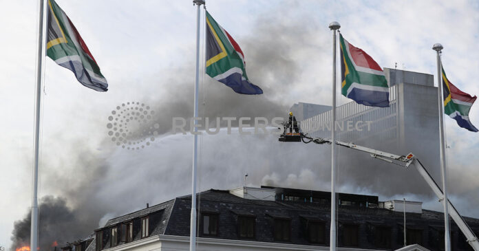 Firefighters work at the national parliament as the fire flared up again, in Cape Town, South Africa, January 3, 2022. REUTERS/Mike Hutchings