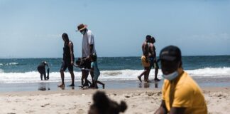 Holidaymakers relax on the South Beach during New Year festivities in Durban after the government lifted COVID-19 restrictions. Photo by Rajesh Jantilal/AFP via Getty Images