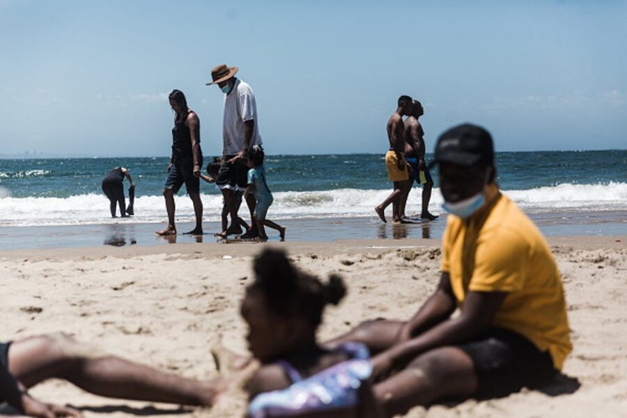 Holidaymakers relax on the South Beach during New Year festivities in Durban after the government lifted COVID-19 restrictions. Photo by Rajesh Jantilal/AFP via Getty Images