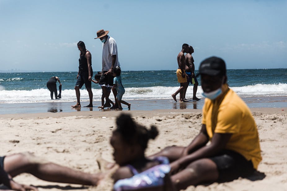 Holidaymakers relax on the South Beach during New Year festivities in Durban after the government lifted COVID-19 restrictions. Photo by Rajesh Jantilal/AFP via Getty Images