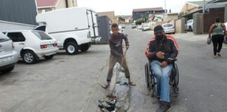 John Martin and Shiloh Felix go out together to collect rubbish in their street in Gqeberha. Photo: Joseph Chirume