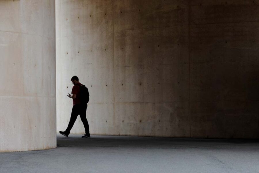 FILE PHOTO: A man walks between buildings at Harvard University in Cambridge