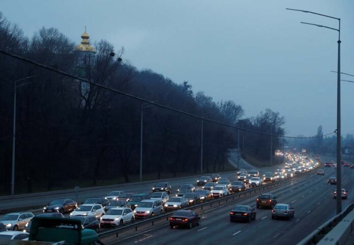 Cars drive towards the exit of the city after Russian President Vladimir Putin authorized a military operation in eastern Ukraine, in Kyiv Russia invades Ukraine