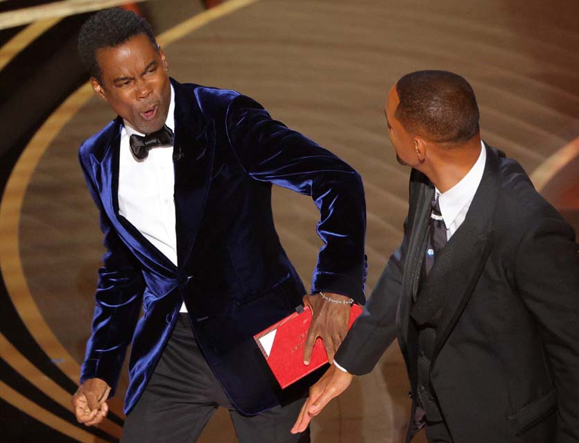 Will Smith hits at Chris Rock as Rock spoke on stage during the 94th Academy Awards in Hollywood, Los Angeles, California, U.S., March 27, 2022. REUTERS/Brian Snyder