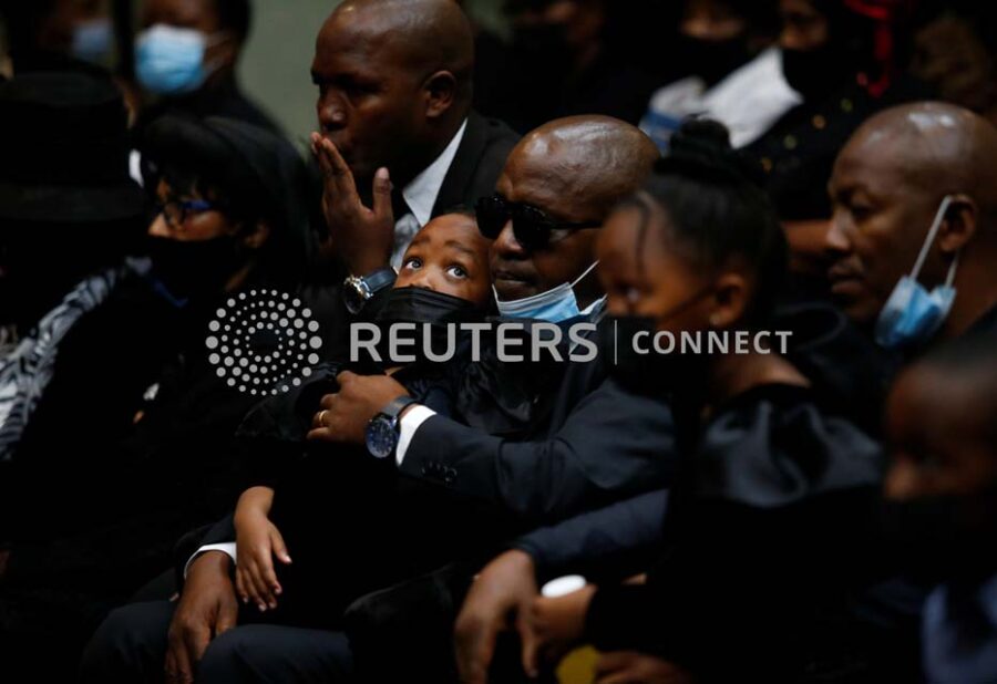 Mali Mjwara holds his daughter Aphelele Mjwara during the funeral of his wife, police diver Sergeant Busisiwe Mjwara who died while searching for flood victims, at her official funeral in Pietermaritzburg