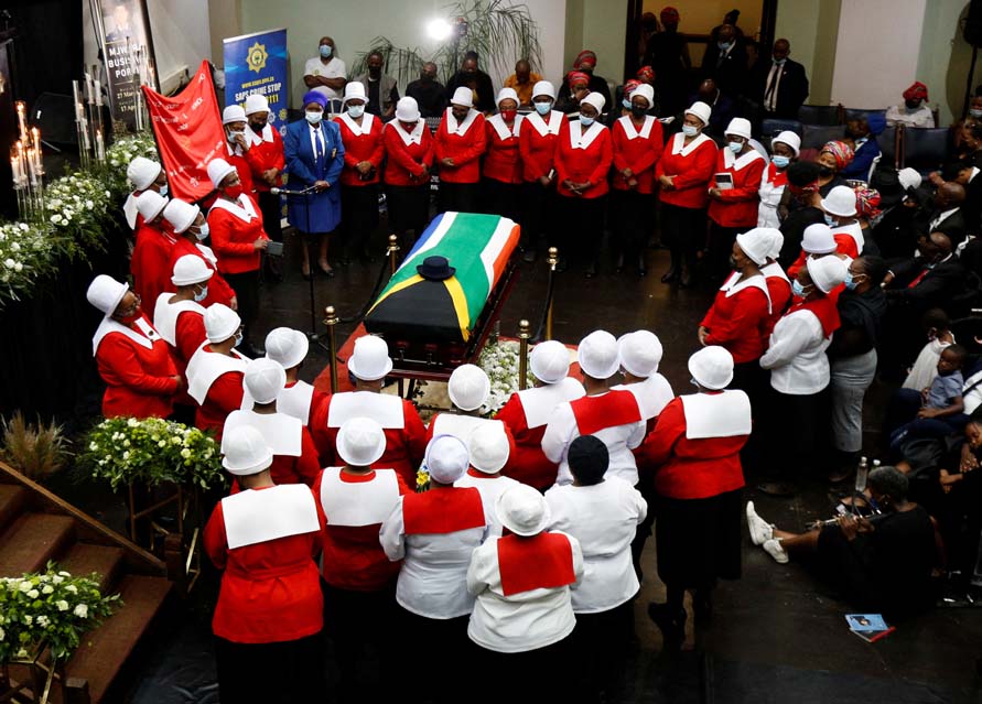 Woman in church uniforms gather around the coffin of police diver Sergeant Busisiwe Mjwara who died while searching for flood victims, at her official funeral in Pietermaritzburg, South Africa, April 22, 2022. RWoman in church uniforms gather around the coffin of police diver Sergeant Busisiwe Mjwara who died while searching for flood victims, at her official funeral in Pietermaritzburg, South Africa, April 22, 2022. REUTERS/Rogan WardEUTERS/Rogan Ward