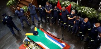 Colleagues gather around the coffin of police diver Sergeant Busisiwe Mjwara who died while searching for flood victims, at her official funeral in Pietermaritzburg