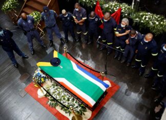 Colleagues gather around the coffin of police diver Sergeant Busisiwe Mjwara who died while searching for flood victims, at her official funeral in Pietermaritzburg