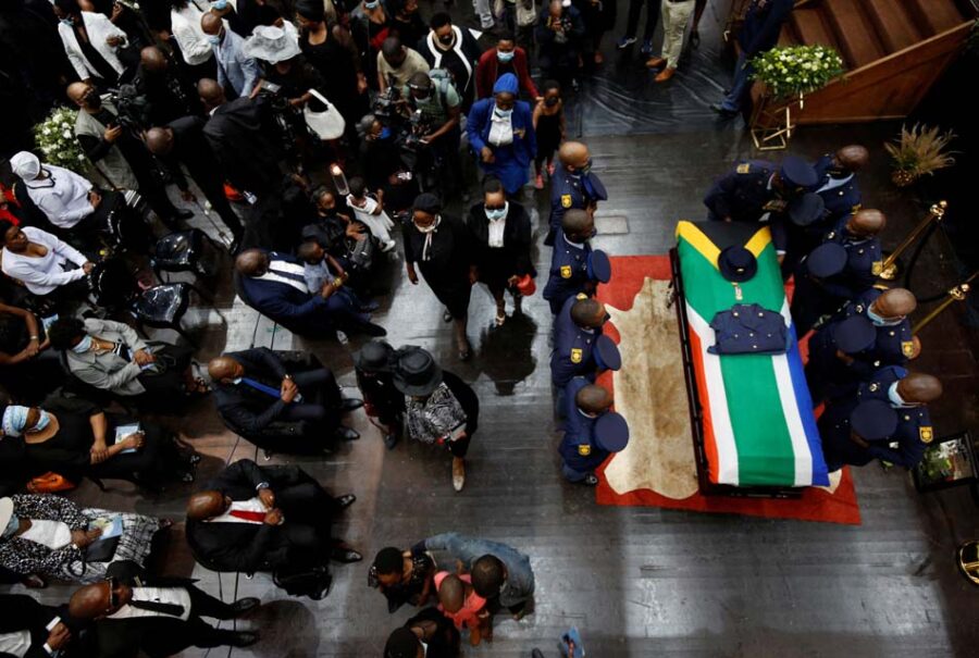 People gather near the coffin of police diver Sergeant Busisiwe Mjwara who died while searching for flood victims, at her official funeral in Pietermaritzburg