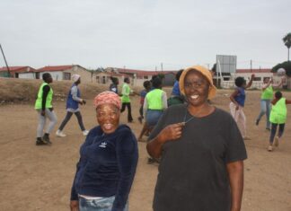 Ntomboxolo Twalingca (left) and Mandisa Ncamiso (right) spent a month cleaning piles of rubbish from this field in KwaNobuhle township in Kariega so they could start a netball club for teenage girls from the community. Photo: Thamsanqa Mbovane