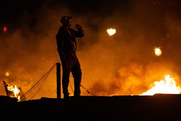 A resident watches the fire. Photo: Ashraf Hendricks