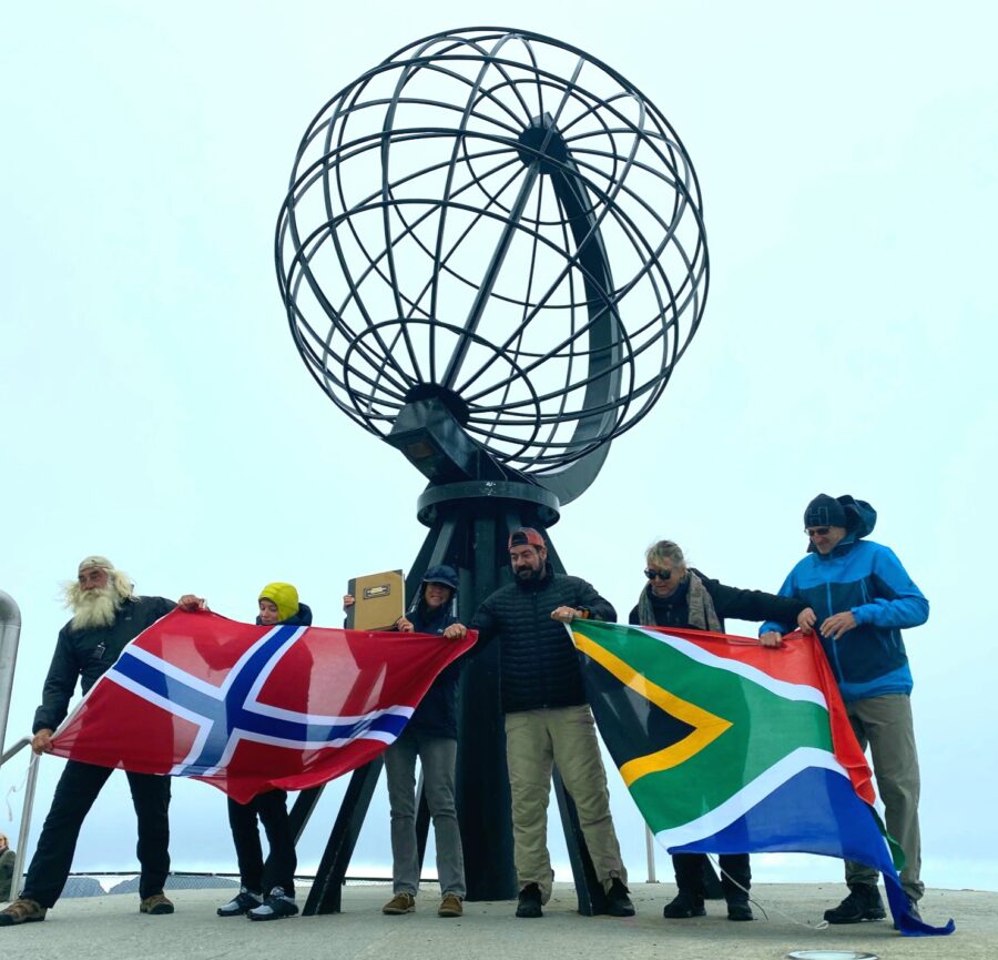 The Kingsley Holgate expedition team celebrates the culmination of their nine month, 35,000 kilometre journey from the southern tip of the African continent to the most northern point in Europe by flying both the South African and Norwegian flags at the famous Nordkapp Globe monument.