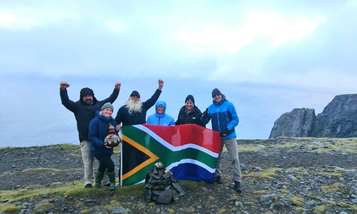 10 Kingsley Holgate Defender Transcontinental Expedition 20220723_211849 The Kingsley Holgate expedition team proudly flies the South African flag on the cliffs of Nordkapp in Norway at the culmination of their successful Hot Cape to Cold Cape transcontinental journey from Cape Agulhas.