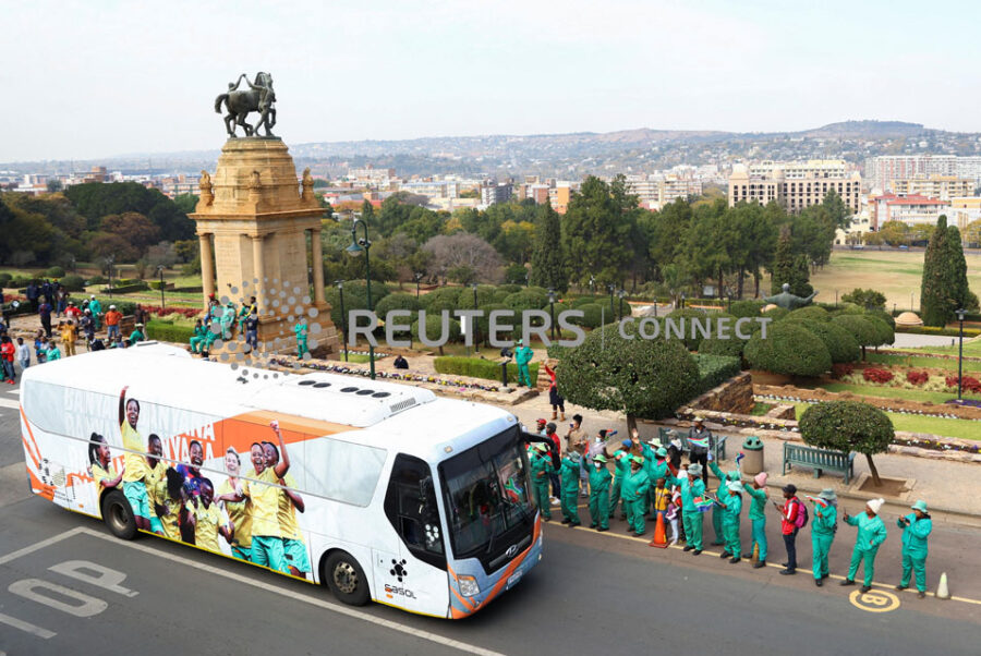 Workers cheer as the bus carrying South Africa women's team arrive to meet with President Cyril Ramaphosa and celebrate winning their first Women's Africa Cup of Nations title in Morocco, at the government's union building in Pretoria, South Africa, July 27, 2022. REUTERS/Siphiwe Sibeko