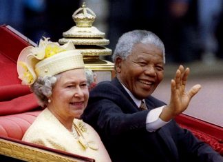 FILE PHOTO: South African President Nelson Mandela is accompanied by Britain's Queen Elizabeth II in a carriage ride to a Buckingham Palace lunch during his state visit, in London, Britain July 9, 1996. REUTERS/Simon Kreitem