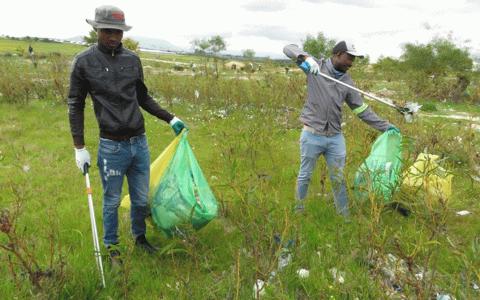 community-clean-up Volunteers fill scores of rubbish bags during river clean-up