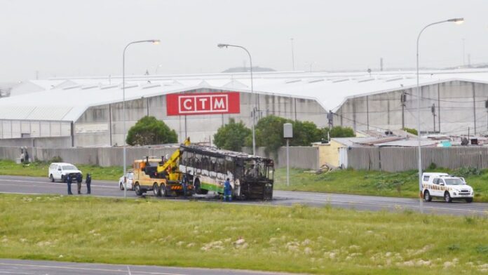 taxi violence Cape Town A burnt Golden Arrow bus is towed from the N2 in Cape Town on Friday. It was the latest in a spate of attacks in Nyanga and Philippi for more than a week, allegedly by Amaphela taxi drivers whose cars were impounded. Photo: Nombulelo Damba-Hendrik.