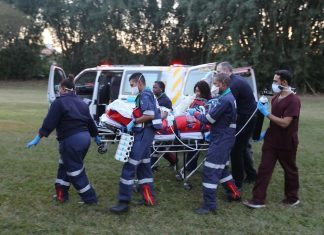 Paramedics for Netcare911 rescue are here seen rushing the critically injured 25-year-old tour guide who was attacked by a giraffe that killed her daughter to hospital.
