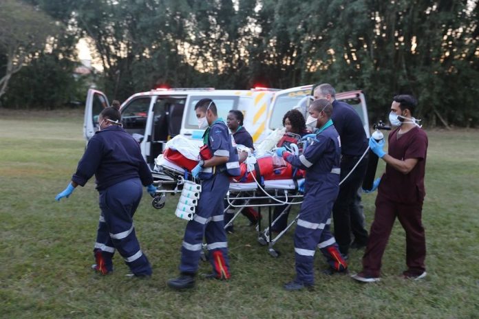 Paramedics for Netcare911 rescue are here seen rushing the critically injured 25-year-old tour guide who was attacked by a giraffe that killed her daughter to hospital.