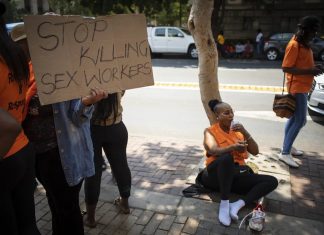 Sex workers and their supporters protest outside the Johannesburg Magistrate’s Court during the first appearance of a man accused of killing six women. EPA-EFE/Kim Ludbrook