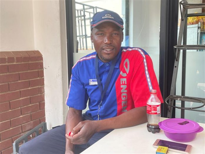 Petrol attendant Lebogang Ramathoka poses for a photo during his shift break at a petrol station in Johannesburg, South Africa, October 7, 2022. Thomson Reuters Foundation/Kim Harrisberg Petrol attendant Lebogang Ramathoka poses for a photo during his shift break at a petrol station in Johannesburg, South Africa, October 7, 2022. Thomson Reuters Foundation/Kim Harrisberg