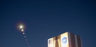 This composite made from ten images shows the progression of the Moon during a total lunar eclipse above the Vehicle Assembly Building, Nov. 8, 2022, at NASA’s Kennedy Space Center in Florida. Visible trailing the Moon in this composite is Mars. Photo Credit: (NASA/Joel Kowsky)