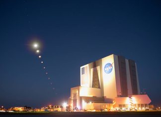 This composite made from ten images shows the progression of the Moon during a total lunar eclipse above the Vehicle Assembly Building, Nov. 8, 2022, at NASA’s Kennedy Space Center in Florida. Visible trailing the Moon in this composite is Mars. Photo Credit: (NASA/Joel Kowsky)