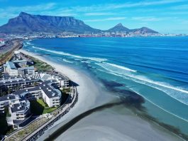 Drone footage from 25 November shows polluted black water from the Diep River estuary flowing into the sea at Milnerton. Photo: Supplied
