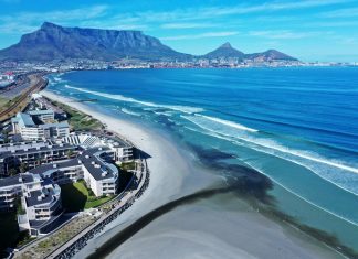 Drone footage from 25 November shows polluted black water from the Diep River estuary flowing into the sea at Milnerton. Photo: Supplied
