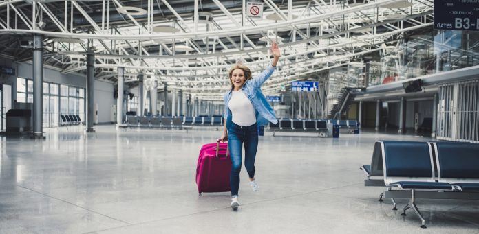 Young woman in airport A Special Message To Anyone Wanting to Leave South Africa Right Now