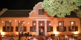 Wine lovers are entertained at a long table in front of Vergelegen’s historic homestead. Photo: A Gorman Photography