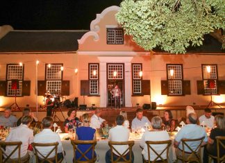 Wine lovers are entertained at a long table in front of Vergelegen’s historic homestead. Photo: A Gorman Photography