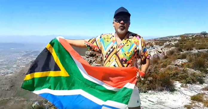 Faried Swartz on Table Mountain singing What the world (and South Africa) needs now