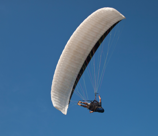 flying above the clouds paraglider