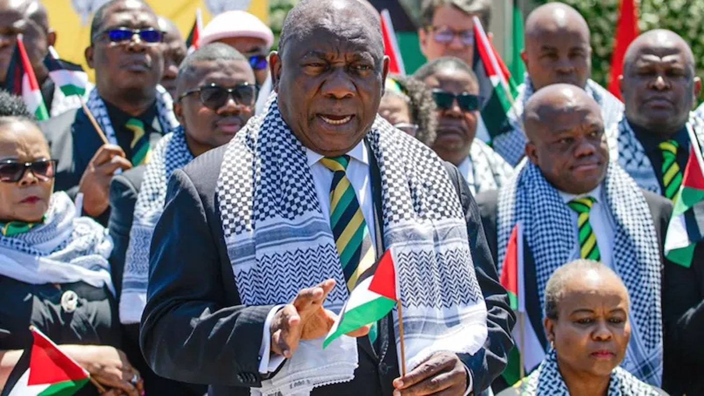President Cyril Ramaphosa wearing a keffiyeh, standing in front of ANC officials Israel embassy south africa is firmly in the spotlight