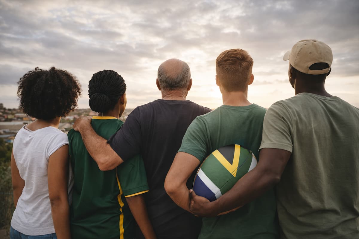 AI-generated image of south africans looking into the horizon, with one clutching a rugby ball. This image illustrates an article that centres around "what does it mean to be a good citizen in South Africa, right now?"