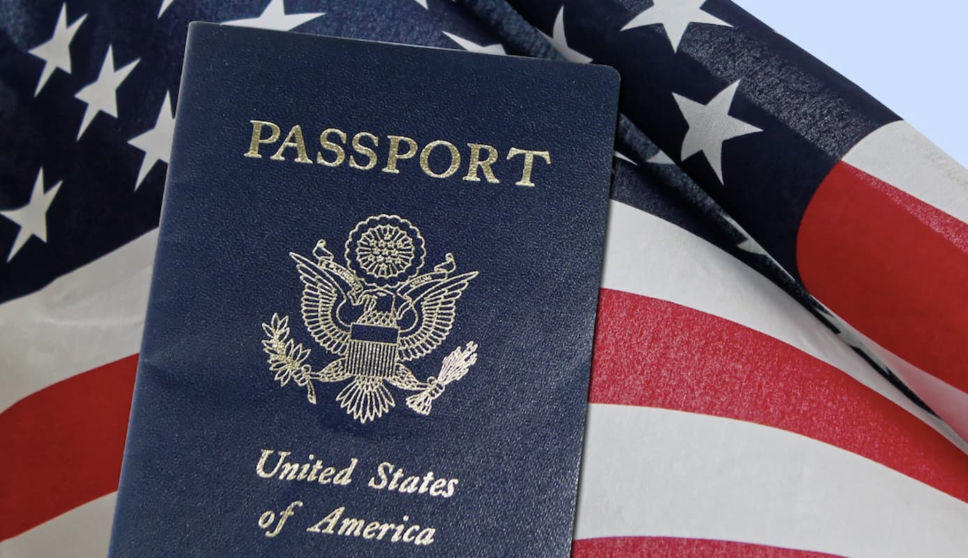 A US passport sitting on the US flag. This image accompanies an article titled 'US passport services: Consular officers heading to Bloemfontein on this date'